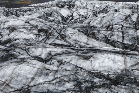 Aerial view of ash streaked glacier ridges in Icelandic daylightの写真素材