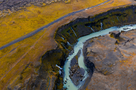 Aerial view of Sigoldugljufur canyon waterfalls and glacial river