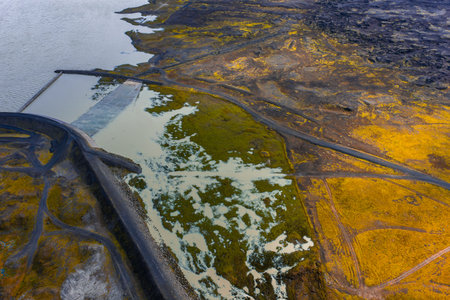 Aerial dam and spillway over lava fields in Icelandic highlands