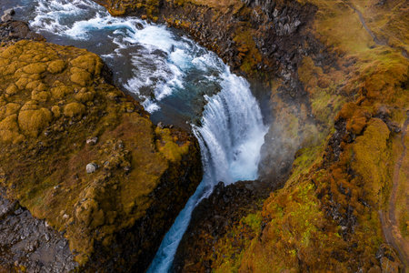 Aerial waterfall drops into canyon in Iceland South Highlands