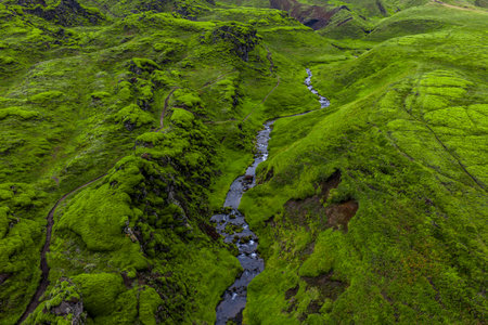 Aerial view of mossy volcanic hills and stream in Iceland highlandsの写真素材