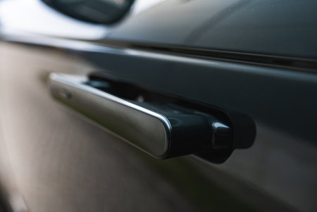 Close up of pop out door handle on dark luxury SUV with soft lightの写真素材