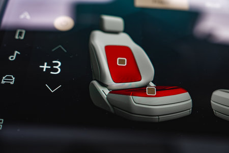 Close up of car infotainment screen with seat zones and controls