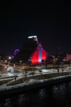 Aerial night view of National Library of Latvia lit in red and whiteの写真素材