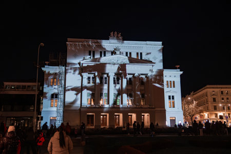 Riga crowd watches projection mapping on Latvian National Operaの写真素材