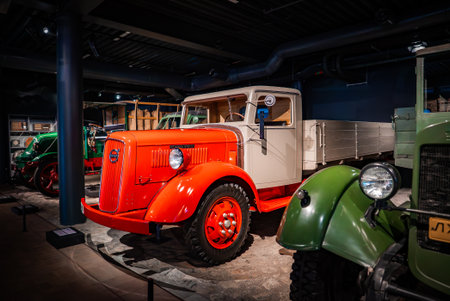 Restored vintage truck with cream cab and orange fenders on displayの写真素材