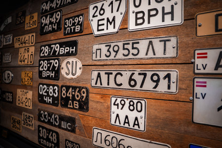 Soviet era license plates on wood wall with SU badge and regional codesの写真素材