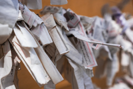 Close up omikuji papers tied at Tokyo shrine strings in focusの写真素材