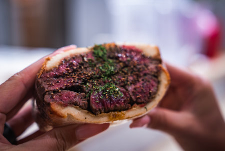 Tokyo wagyu sandwich close up with seared marbled beef and herbsの写真素材