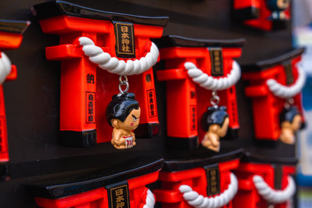 Red torii magnet display with shimenawa and sumo charms in Tokyoの写真素材