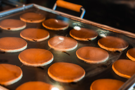 Dorayaki pancakes cooking on griddle at Tokyo street marketの写真素材
