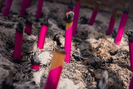 Pink incense sticks burn in sand cauldron at Sensoji, Tokyoの写真素材