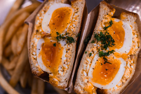 Tokyo tamago sando close up with soft boiled eggs and friesの写真素材