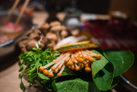 Fresh enoki and greens for Japanese hot pot in Osaka restaurantの写真素材