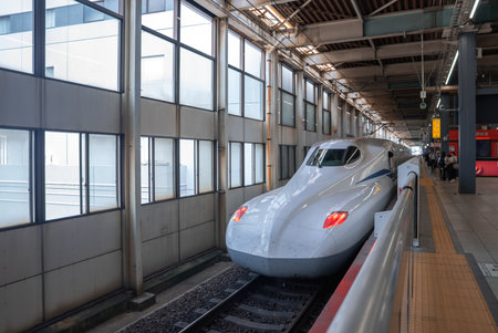 High-speed train arrives at indoor platform in Osaka with silver bodyの写真素材