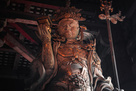 Guardian statue inside dim wooden temple hall in Nara, Japanの写真素材