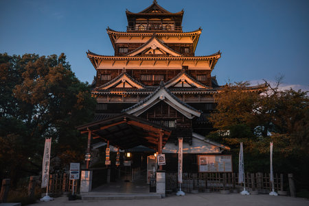 Castle tenshu at dusk with gate and banners in Osaka, Japanの写真素材