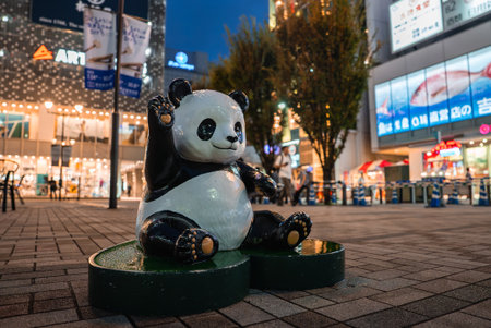 Panda statue on pedestals in a Tokyo shopping districtの写真素材