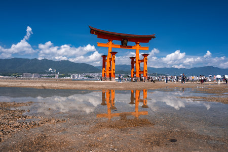 Great Torii of Itsukushima at low tide with crowds on Miyajima, Japanの写真素材