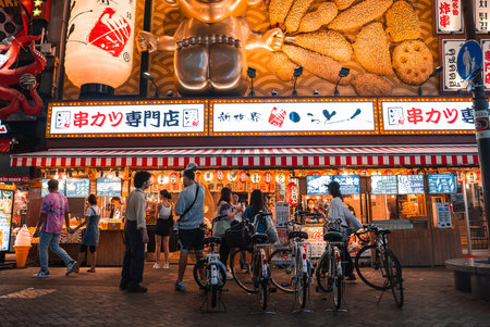 Evening kushikatsu shop in Dotonbori Osaka with neon signs and artの写真素材