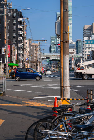 Osaka intersection with Abeno Harukas and morning traffic activityの写真素材