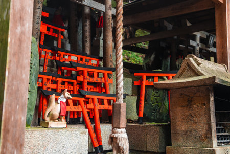 Miniature torii and kitsune at Fushimi Inari Taisha, Kyoto shrine nookの写真素材