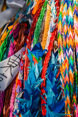 Close view of senbazuru origami cranes with white ribbon in Hiroshimaの写真素材