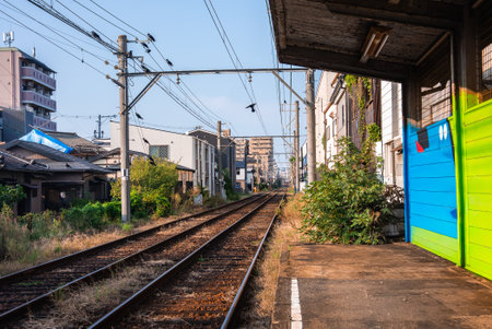 Local commuter tracks and platform in a quiet Osaka neighborhoodの写真素材
