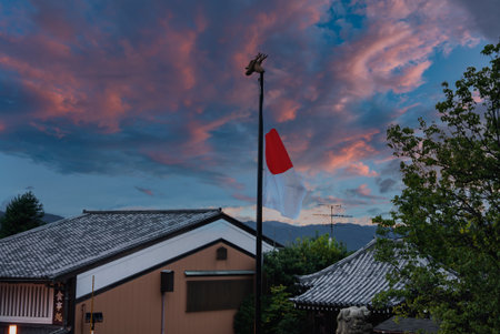 Kyoto machiya rooftops and temple at sunsetの写真素材