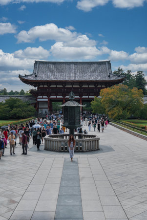 Crowds cross stone plaza toward Nandaimon at Todai ji, Naraの写真素材