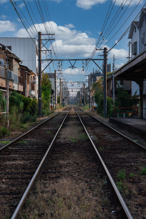 Ground level railway tracks through Osaka residential districtの写真素材