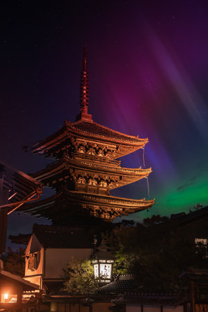 Five story pagoda over machiya roofs at night in Kyoto, Japanの写真素材