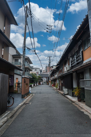 Kyoto lane with machiya houses leading to a small shrine gateの写真素材