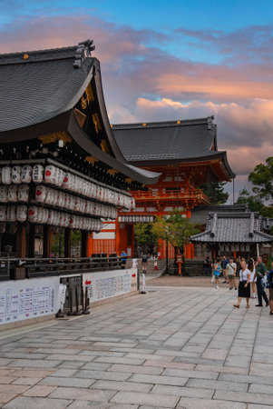 Visitors walk past lantern lit pavilion at Fushimi Inari, Kyotoの写真素材