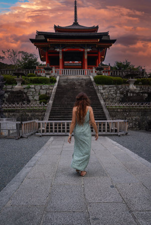 Visitor approaches Kiyomizu dera gate and hall at dusk in Kyotoの写真素材