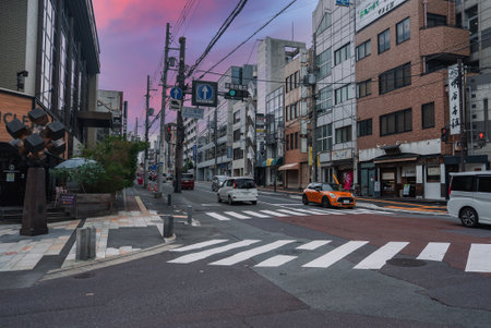 Nara city street at dusk with cars and zebra crossing in Japanの写真素材