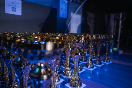 Gold trophies on dim stage before awards at theater or auditoriumの写真素材
