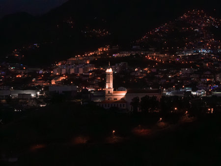Night view of church tower and hillside lights in Funchal, Madeira