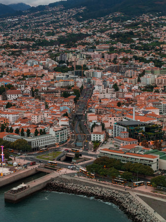 Aerial dusk view of Funchal city, marina, and hills in Madeiraの写真素材
