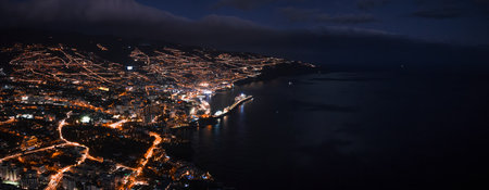 Night aerial of Funchal, Madeira, orange grids and crescent bayの写真素材