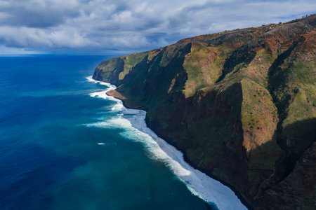 Aerial cliffs and surf along Ponta do Pargo, Madeira coastlineの写真素材