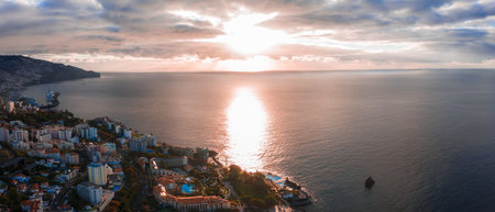 Aerial panorama of Funchal coastline at sunrise with Atlantic glowの写真素材