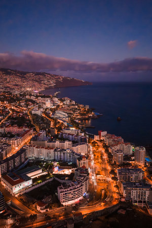 Aerial twilight view of Funchal curving along the Atlantic bayの写真素材