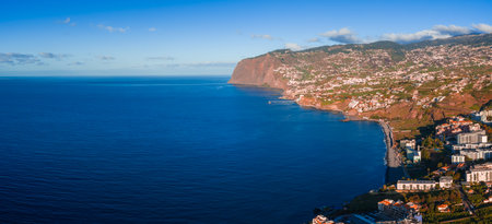 Funchal cascading to the Atlantic with Cabo Girao on Madeira coastの写真素材