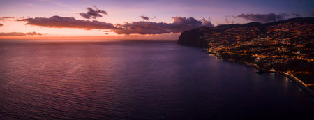 Twilight view of Funchal lights along Madeira coastline at sunsetの写真素材
