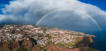 Aerial view of Funchal coast with rainbow over Atlantic, Madeiraの写真素材