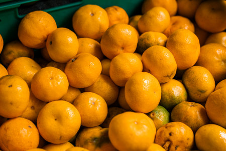 Tangerines in green crate at a market stall in Funchal, Madeiraの写真素材
