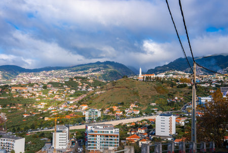 Funchal, Madeira hillside cityscape with white church and bell towerの写真素材