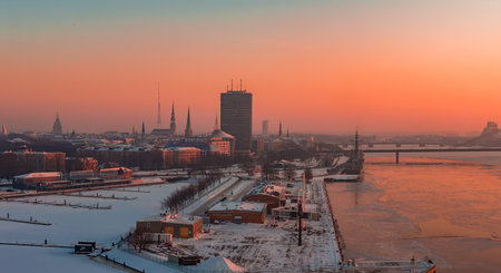 Riga Old Town at winter sunset with Daugava River and spiresの写真素材