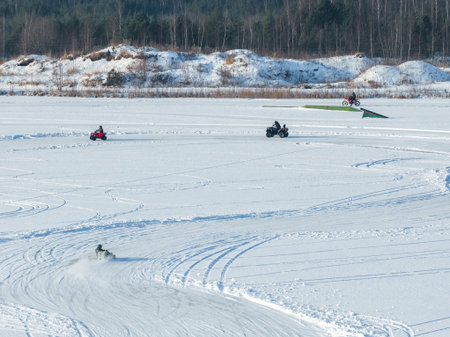 Aerial view of ice racing track on frozen lake with riders and ATVsの写真素材